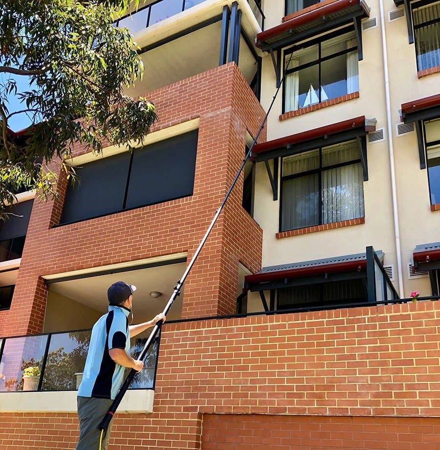 Professional window cleaner working on exterior windows